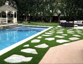 Artificial grass surrounding a pool 